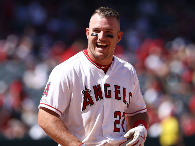 ANAHEIM, CALIFORNIA - APRIL 07: Mike Trout #27 of the Los Angeles Angels of Anaheim has a laugh with Elvis Andrus #1 of the Texas Rangers (not in photo) after the fourth inning of the MLB game at Angel Stadium of Anaheim on April 07, 2019 in Anaheim, California. The Angels defeated the Rangers 7-2.