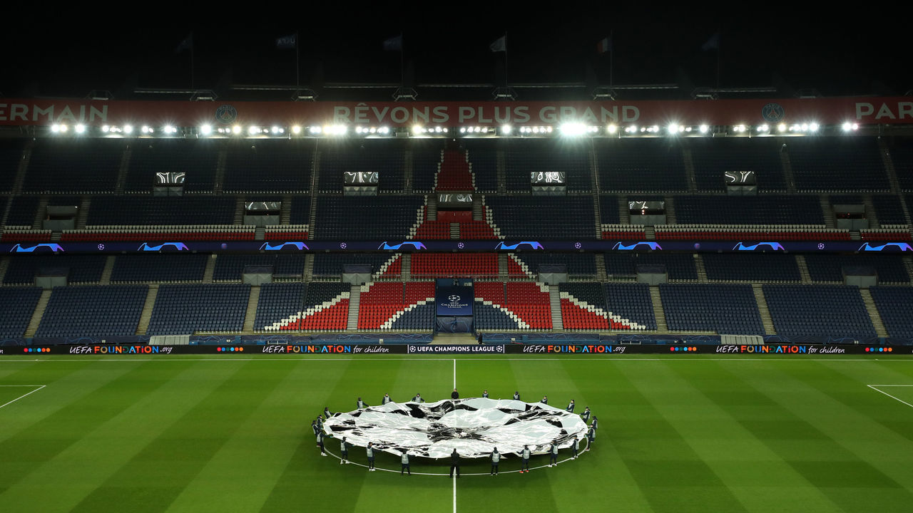 PARIS, FRANCE - MARCH 11: (FREE FOR EDITORIAL USE) In this handout image provided by UEFA, General view inside the empty stadium as the two teams line up prior to the UEFA Champions League round of 16 second leg match between Paris Saint-Germain and Borussia Dortmund at Parc des Princes on March 11, 2020 in Paris, France. The match is played behind closed doors as a precaution against the spread of COVID-19 (Coronavirus).