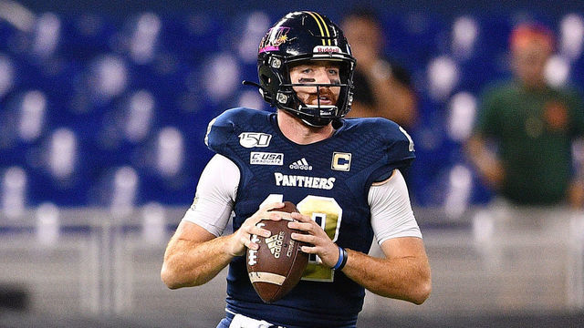MIAMI, FLORIDA - NOVEMBER 23: James Morgan #12 of the FIU Golden Panthers looks to pass against the Miami Hurricanes in the first half at Marlins Park on November 23, 2019 in Miami, Florida.