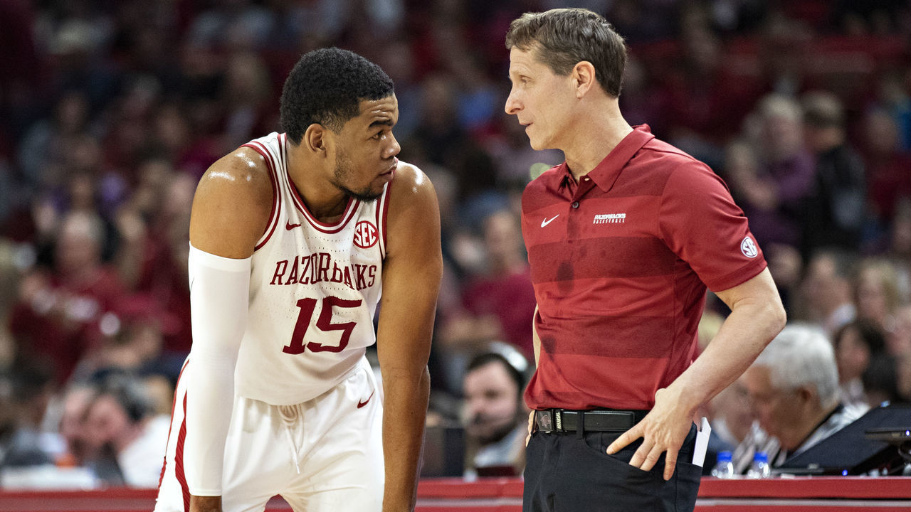 FAYETTEVILLE, AR - FEBRUARY 15: Head coach Eric Musselman talks with Mason Jones #15 of the Arkansas Razorbacks during a time out in the second half of a game against the Mississippi State Bulldogs at Bud Walton Arena on February 15, 2020 in Fayetteville, Arkansas. The Bulldogs defeated the Razorbacks 78-77.