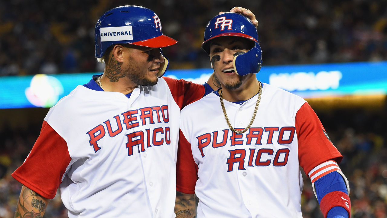 LOS ANGELES, CA - MARCH 22: Yadier Molina #4 and Javier Baez #9 of team Puerto Rico walk into the dugout after both being out on a double play in the eighth inning against the United States during Game 3 of the Championship Round of the 2017 World Baseball Classic at Dodger Stadium on March 22, 2017 in Los Angeles, California. Team United States won 8-0.