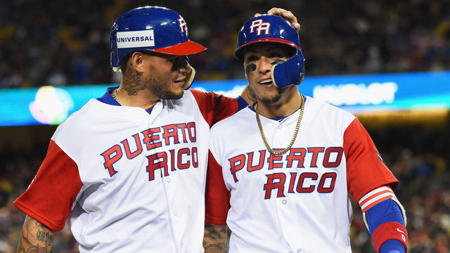LOS ANGELES, CA - MARCH 22: Yadier Molina #4 and Javier Baez #9 of team Puerto Rico walk into the dugout after both being out on a double play in the eighth inning against the United States during Game 3 of the Championship Round of the 2017 World Baseball Classic at Dodger Stadium on March 22, 2017 in Los Angeles, California. Team United States won 8-0.