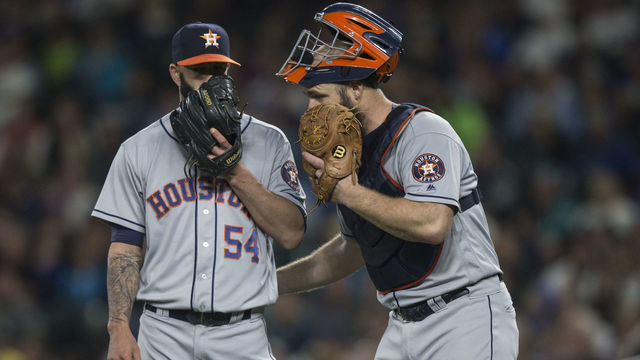 SEATTLE, WA - SEPTEMBER 17: Catcher Evan Gattis #11, right, of the Houston Astros meets at the mound with starting pitcher Mike Fiers #54 of the Houston Astros during a game against the Seattle Mariners at Safeco Field on September 17, 2016 in Seattle, Washington. The Astros won the game 2-1.