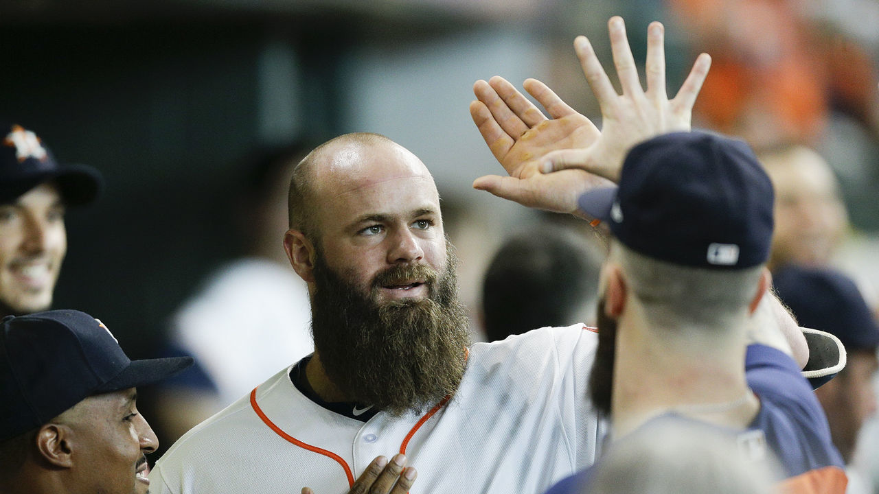 HOUSTON, TX - JULY 14: Evan Gattis #11 of the Houston Astros receives high fives from the dugout after hitting a home run in the fifth inning against the Detroit Tigers at Minute Maid Park on July 14, 2018 in Houston, Texas.