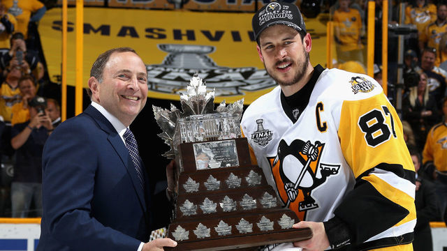 NASHVILLE, TN - JUNE 11: NHL commissioner Gary Bettman (L) poses with Sidney Crosby #87 of the Pittsburgh Penguins as he presents him the Conn Smythe Trophy after the Penguins defeated the Nashville Predators 2-0 to win the 2017 NHL Stanley Cup Final at Bridgestone Arena on June 11, 2017 in Nashville, Tennessee.