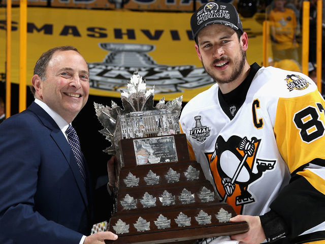 NASHVILLE, TN - JUNE 11: NHL commissioner Gary Bettman (L) poses with Sidney Crosby #87 of the Pittsburgh Penguins as he presents him the Conn Smythe Trophy after the Penguins defeated the Nashville Predators 2-0 to win the 2017 NHL Stanley Cup Final at Bridgestone Arena on June 11, 2017 in Nashville, Tennessee.