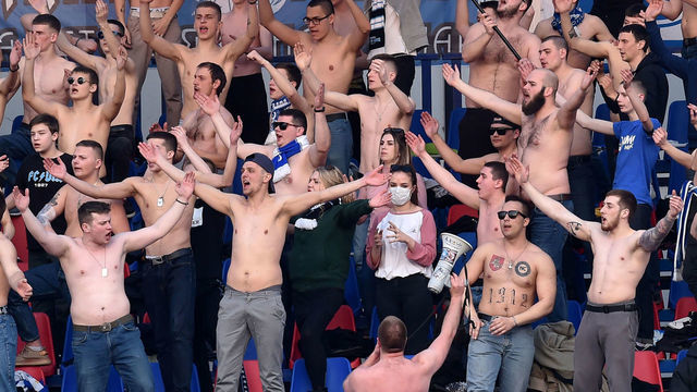 Fans of FC Minsk support their team during the Belarus Championship foolball match between FC Minsk and FC Dinamo-Minsk in Minsk, on March 28, 2020. - In stark contrast to leagues elsewhere on the European continent, the Belarus championship continues.