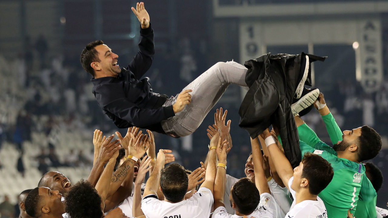 Al-Sadd's Spanish coach Xavi is thrown into the air by his players as they celebrate winning the final match of the Qatar Cup against Al-Duhail at the Jassim Bin Hamad Stadium on January 17, 2020. - Al-Sadd won the match 4-0.