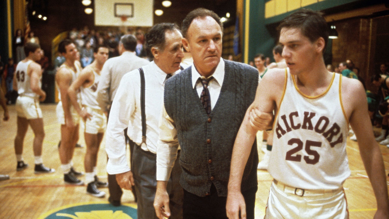 "The coach Norman Dale, played by the American actor Gene Hackman, grasps to the arm of a basketball player before a match and rebukes him, in a scene from the engaging dramatic movie Hoosiers. USA, 1986. "