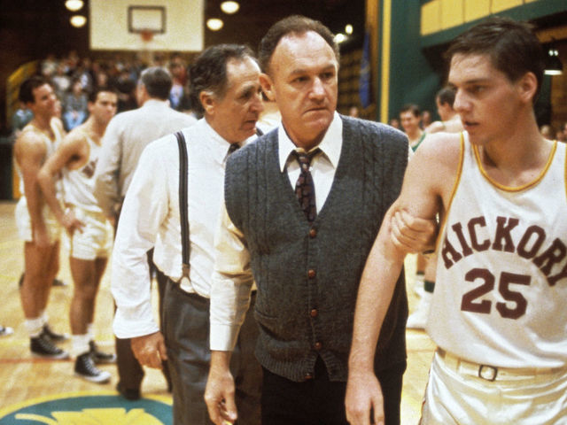 "The coach Norman Dale, played by the American actor Gene Hackman, grasps to the arm of a basketball player before a match and rebukes him, in a scene from the engaging dramatic movie Hoosiers. USA, 1986. "