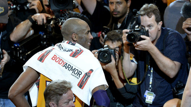 Kobe Bryant #24 of the Los Angeles Lakers is photographed by the media after his final game against the Utah Jazz on April 13, 2016 at Staples Center in Los Angeles, California.