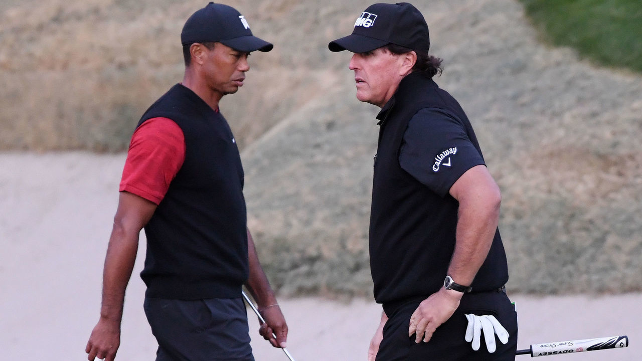 LAS VEGAS, NV - NOVEMBER 23: Tiger Woods and Phil Mickelson walk on the 18th hole during The Match: Tiger vs Phil at Shadow Creek Golf Course on November 23, 2018 in Las Vegas, Nevada.