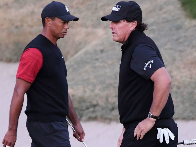 LAS VEGAS, NV - NOVEMBER 23: Tiger Woods and Phil Mickelson walk on the 18th hole during The Match: Tiger vs Phil at Shadow Creek Golf Course on November 23, 2018 in Las Vegas, Nevada.