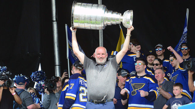 ST LOUIS, MO - JUN 15: St. Louis Blues general manager Doug Armstrong hoists the Stanley Cup at a post parade rally on the Arch Grounds after the St. Louis Blues victory parade held on June 15, 2019, in downtown, St. Louis, Mo.