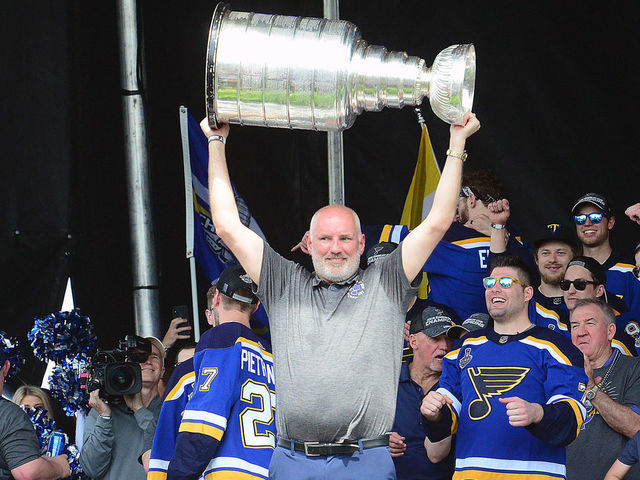 ST LOUIS, MO - JUN 15: St. Louis Blues general manager Doug Armstrong hoists the Stanley Cup at a post parade rally on the Arch Grounds after the St. Louis Blues victory parade held on June 15, 2019, in downtown, St. Louis, Mo.