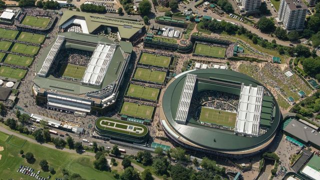 TOPSHOT - An aerial photograph taken from a helicopter shows a general view of The All England Lawn Tennis Club in Wimbledon, southwest London, on the fourth day of the 2019 Wimbledon Championships on July 4, 2019.