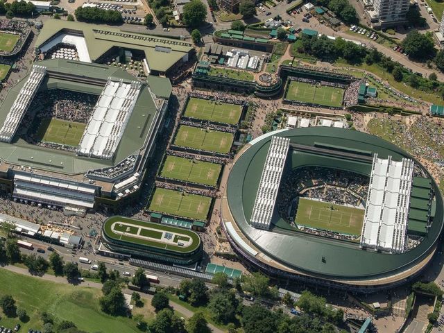TOPSHOT - An aerial photograph taken from a helicopter shows a general view of The All England Lawn Tennis Club in Wimbledon, southwest London, on the fourth day of the 2019 Wimbledon Championships on July 4, 2019.