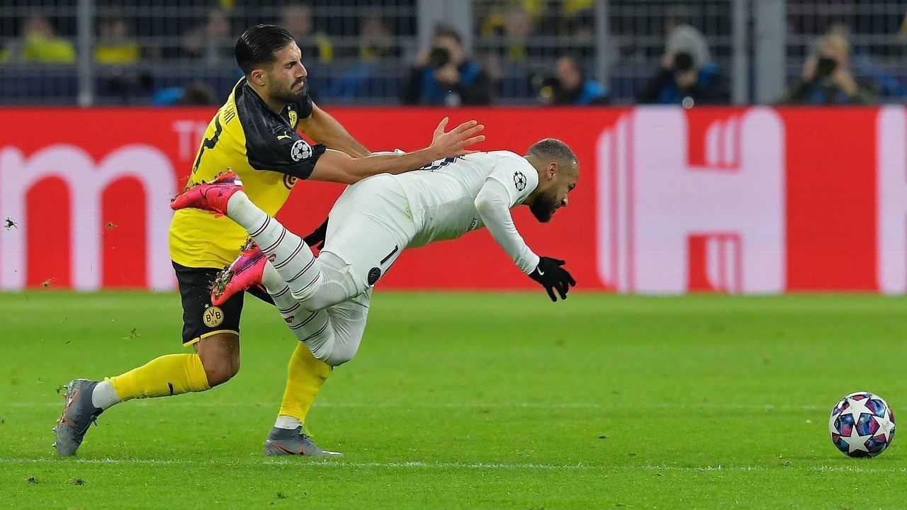 Paris Saint-Germain's Brazilian forward Neymar (R) goes down after a challange by Dortmund's German midfielder Emre Can during the UEFA Champions League Last 16, first-leg football match BVB Borussia Dortmund v Paris Saint-Germain (PSG) in Dortmund, western Germany, on February 18, 2020.
