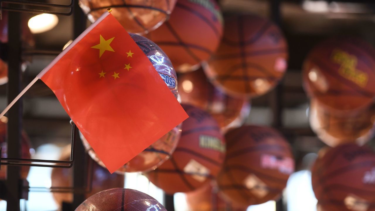 The Chinese flag is seen with a display of basketballs in the National Basketball Association (NBA) store in Beijing on October 9, 2019. - Chinese state media slammed the NBA for an "about-face" on October 9 after the body said it would not apologise for a tweet by the Houston Rockets general manager supporting pro-democracy protests in Hong Kong.