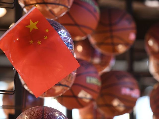 The Chinese flag is seen with a display of basketballs in the National Basketball Association (NBA) store in Beijing on October 9, 2019. - Chinese state media slammed the NBA for an "about-face" on October 9 after the body said it would not apologise for a tweet by the Houston Rockets general manager supporting pro-democracy protests in Hong Kong.