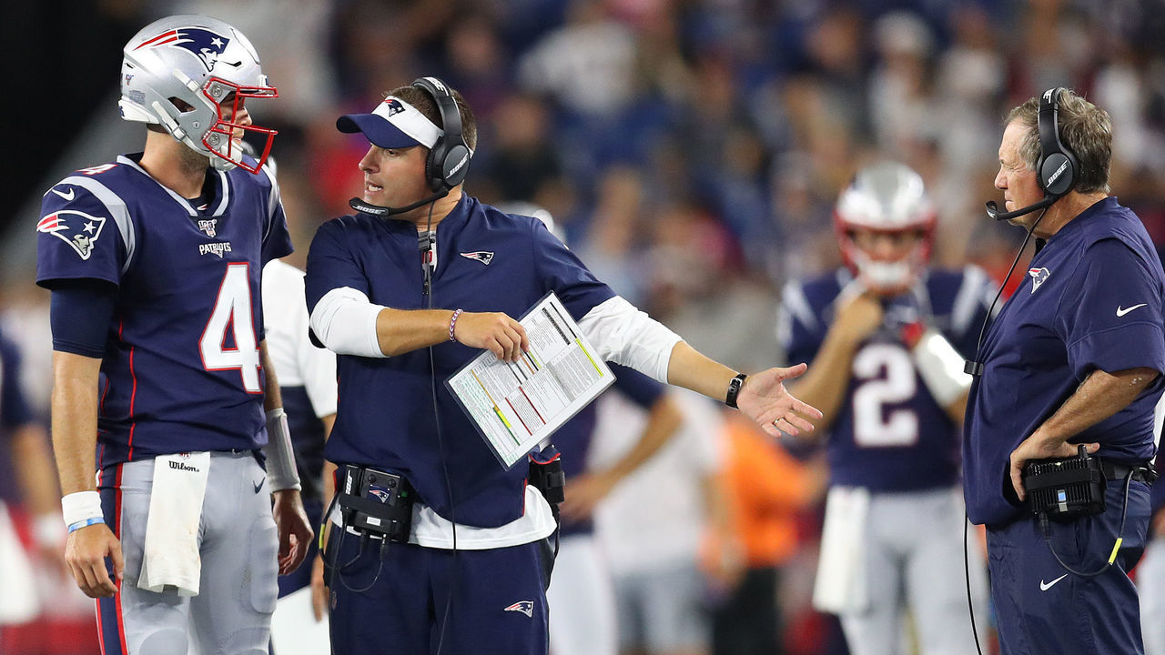 FOXBOROUGH, MASSACHUSETTS - AUGUST 22: Jarrett Stidham #4 of the New England Patriots talks with Offensive Coordinator Josh McDaniels and Head Coach Bill Belichick during the preseason game between the Carolina Panthers and the New England Patriots at Gillette Stadium on August 22, 2019 in Foxborough, Massachusetts.