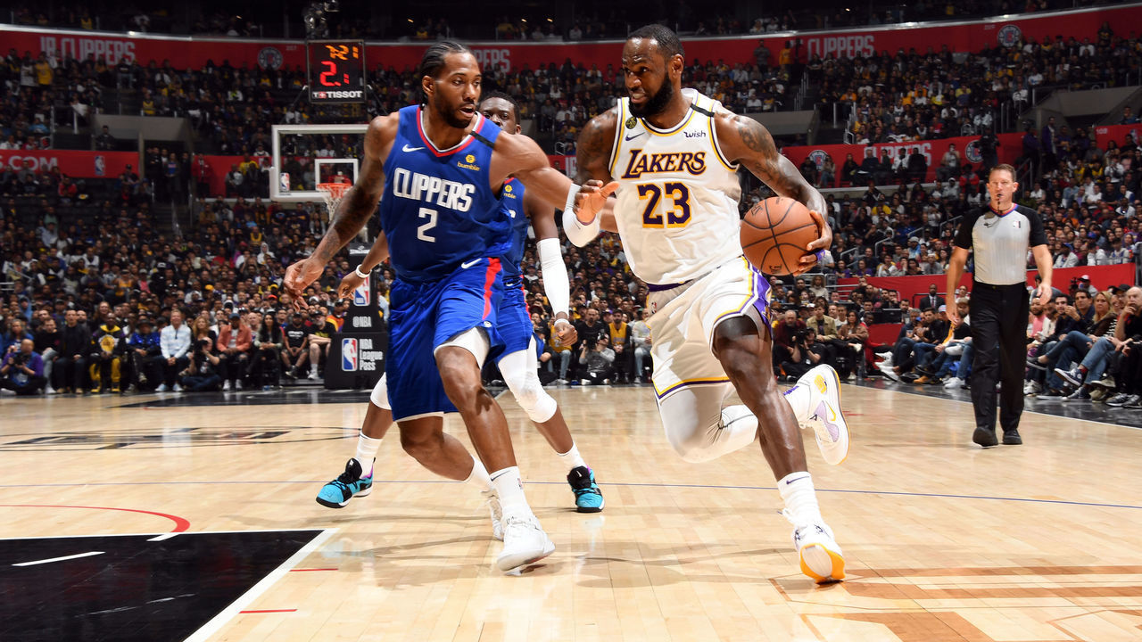 LOS ANGELES, CA - MARCH 8: Kawhi Leonard #2 of the LA Clippers plays defense while LeBron James #23 of the Los Angeles Lakers handles the ball on March 8, 2020 at STAPLES Center in Los Angeles, California. NOTE TO USER: User expressly acknowledges and agrees that, by downloading and/or using this Photograph, user is consenting to the terms and conditions of the Getty Images License Agreement. Mandatory Copyright Notice: Copyright 2020 NBAE