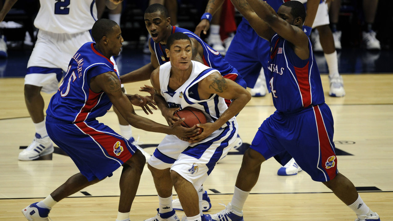7 APR 2008: Mario Chalmers (15) and Sherron Collins (4) of the University of Kansas surround Derrick Rose (23) of the University of Memphis during final game of the 2008 NCAA Photos via Getty Images Final Four Division I Men's Basketball championships held at the Alamodome in San Antonio, TX. Kansas defeated Memphis 75-68 to win the national title. Brett Wilhelm/NCAA Photos via Getty Images