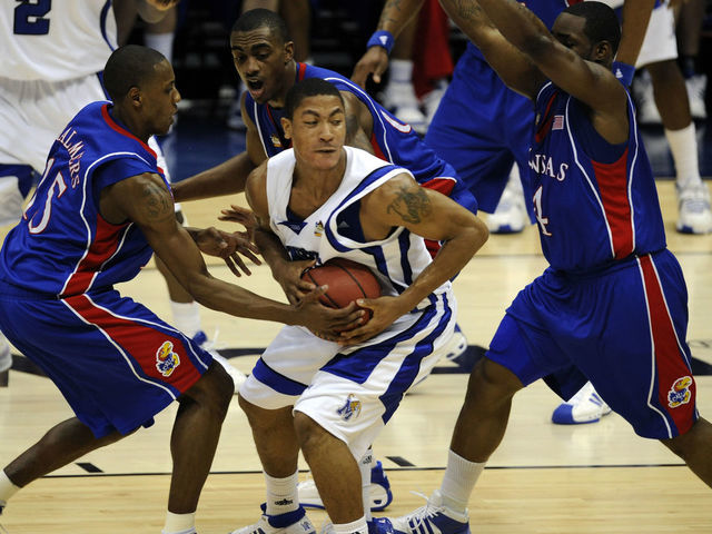 7 APR 2008: Mario Chalmers (15) and Sherron Collins (4) of the University of Kansas surround Derrick Rose (23) of the University of Memphis during final game of the 2008 NCAA Photos via Getty Images Final Four Division I Men's Basketball championships held at the Alamodome in San Antonio, TX. Kansas defeated Memphis 75-68 to win the national title. Brett Wilhelm/NCAA Photos via Getty Images