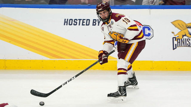 BUFFALO, NY - APRIL 13: Justin Richards #19 of the Minnesota-Duluth Bulldogs skates up ice with the puck during the first period against the Massachusetts Minutemen at KeyBank Center on April 13, 2019 in Buffalo, New York.