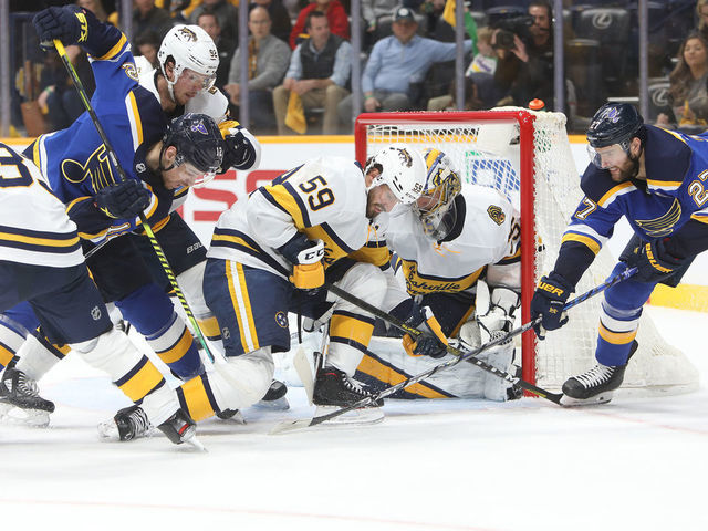 NASHVILLE, TN - FEBRUARY 16: St. Louis Blues left wing Zach Sanford (12) and defenseman Alex Pietrangelo (27) battle for the puck with Nashville Predators right wing Viktor Arvidsson (33), of Sweden, center Ryan Johansen (92), defenseman Roman Josi (59) and goalie Pekka Rinne (35) during the NHL game between the Nashville Predators and St. Louis Blues, held on February 16, 2020, at Bridgestone Arena in Nashville, Tennessee.