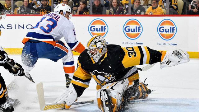 PITTSBURGH, PA - NOVEMBER 19: Matt Murray #30 of the Pittsburgh Penguins makes a save against Mathew Barzal #13 of the New York Islanders at PPG PAINTS Arena on November 19, 2019 in Pittsburgh, Pennsylvania.