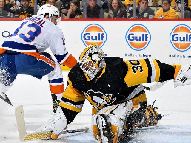 PITTSBURGH, PA - NOVEMBER 19: Matt Murray #30 of the Pittsburgh Penguins makes a save against Mathew Barzal #13 of the New York Islanders at PPG PAINTS Arena on November 19, 2019 in Pittsburgh, Pennsylvania.