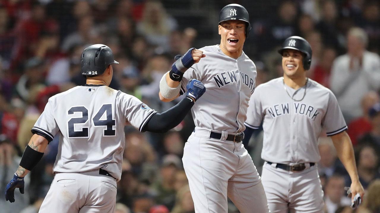 BOSTON, MA - OCTOBER 06: Gary Sanchez #24 and Aaron Judge #99 of the New York Yankees celebrate after Sanchez hit a three-run home run as teammate Giancarlo Stanton #27 watches during the seventh inning of Game Two of the American League Division Series against the Boston Red Sox at Fenway Park on October 6, 2018 in Boston, Massachusetts.