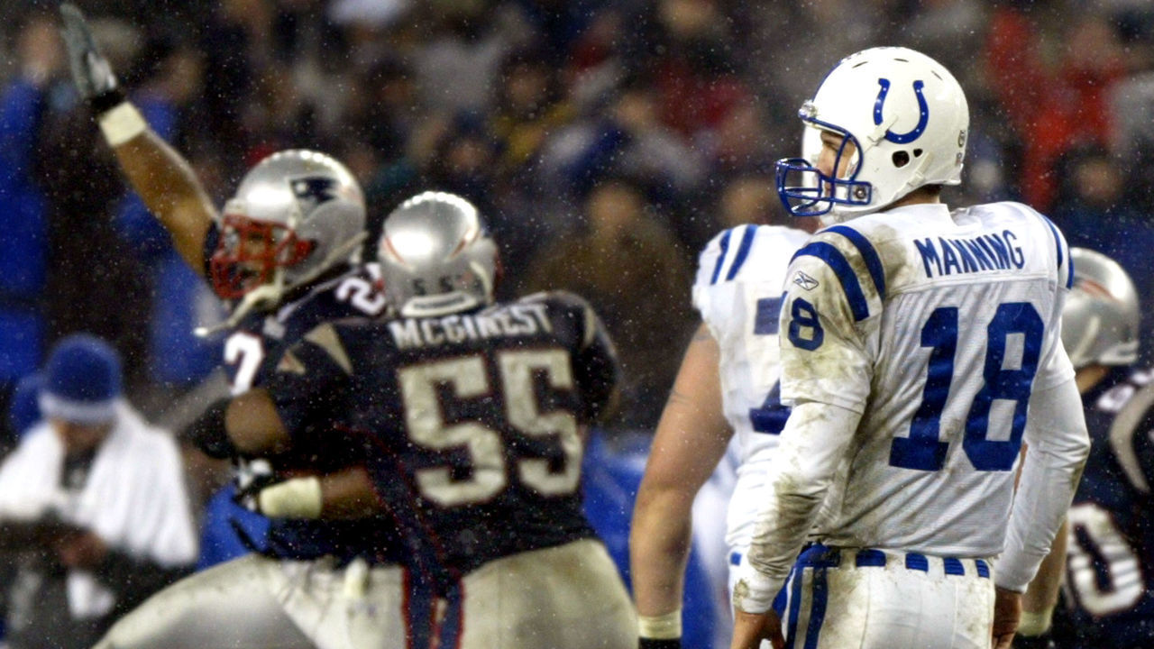 FOXBOROUGH, MA - JANUARY 18: Indianapolis Colts quarterback Peyton Manning watches as New England Patriots cornerback Ty Law, left, gets the ball and a hug from Willie McGinest after an interception.