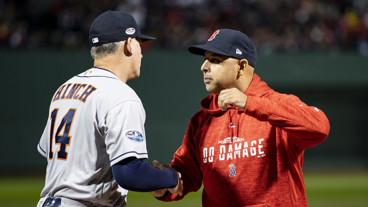 BOSTON, MA - OCTOBER 13: Manager Alex Cora of the Boston Red Sox high fives manager A.J. Hinch of the Houston Astros before game one of the American League Championship Series on October 13, 2018 at Fenway Park in Boston, Massachusetts.