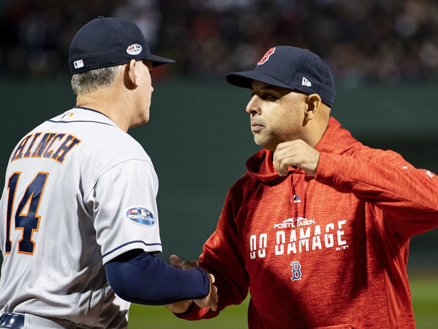 BOSTON, MA - OCTOBER 13: Manager Alex Cora of the Boston Red Sox high fives manager A.J. Hinch of the Houston Astros before game one of the American League Championship Series on October 13, 2018 at Fenway Park in Boston, Massachusetts.
