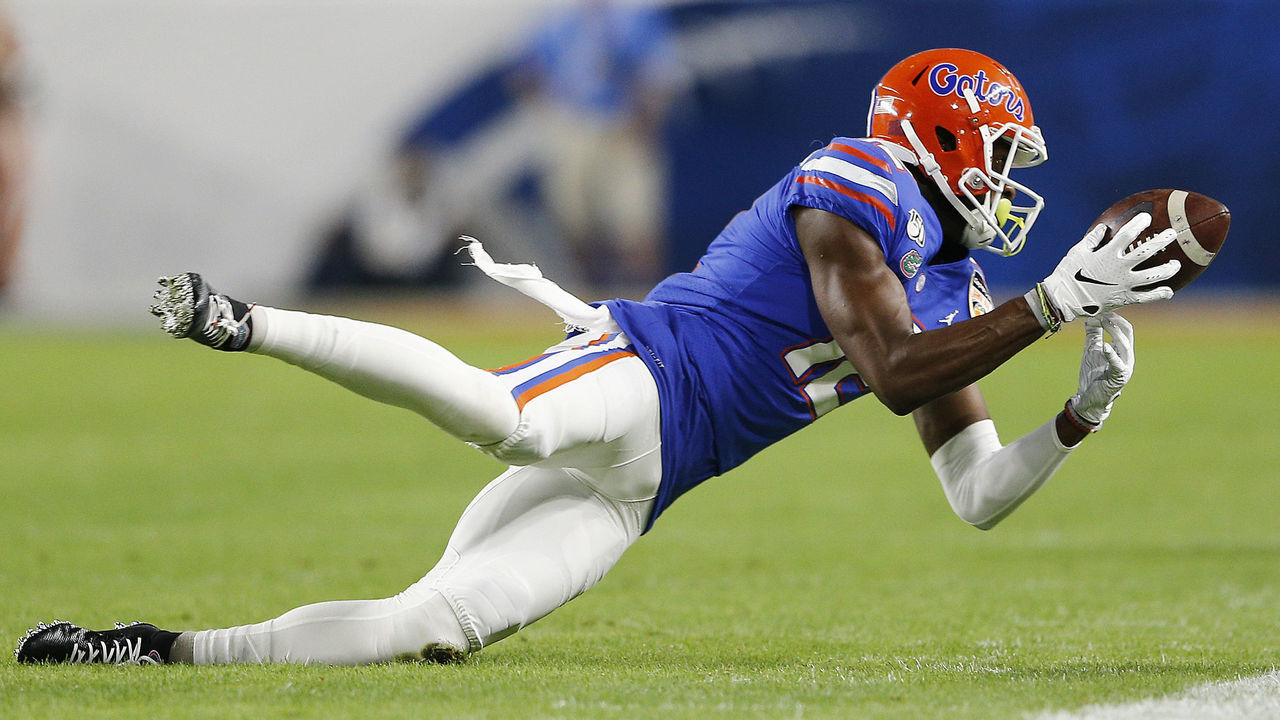MIAMI, FLORIDA - DECEMBER 30: Van Jefferson #12 of the Florida Gators dives to attempt to make a catch against the Virginia Cavaliers during the first half of the Capital One Orange Bowl at Hard Rock Stadium on December 30, 2019 in Miami, Florida.