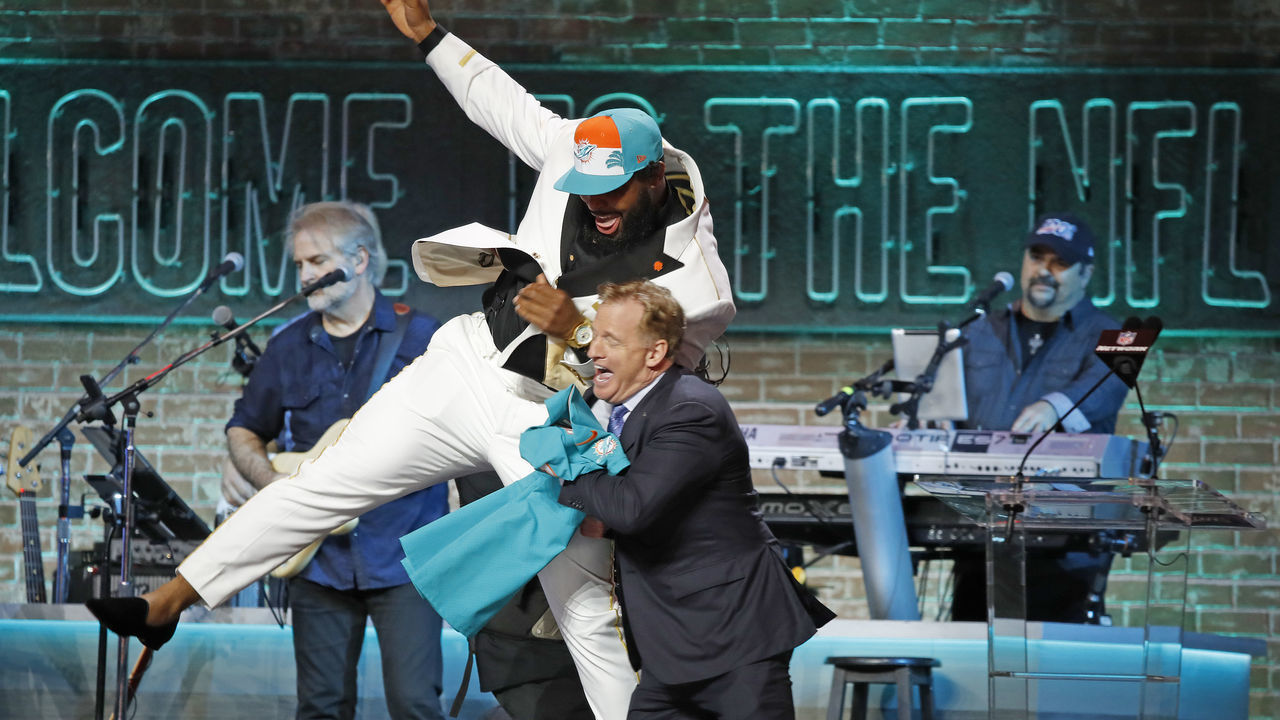 NASHVILLE, TENNESSEE - APRIL 25: Christian Wilkins jump into NFL Commissioner Roger Goodell after he is drafted thirteenth overall by the Miami Dolphins on day 1 of the 2019 NFL Draft on April 25, 2019 in Nashville, Tennessee.