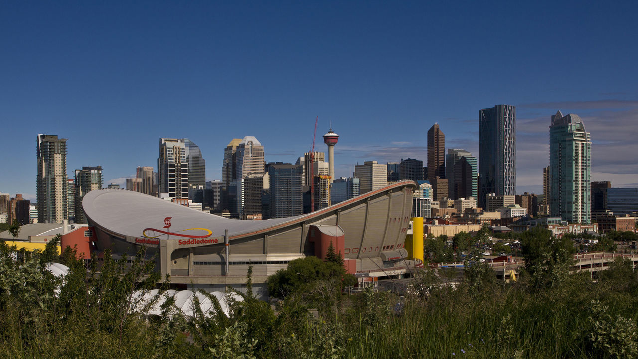 CALGARY, CANADA - JULY 3: The downtown skyline, the Saddledome, and Stampede Park is viewed from a hill to the southeast on July 3, 2012 in Calgary, Canada. Calgary, home to the world famous Stampede, continues to enjoy the benefits of an energy boom that continues across the Alberta province.