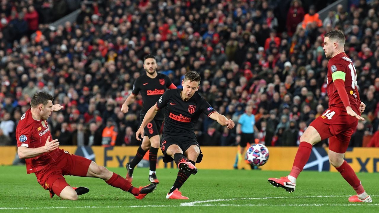 Atletico Madrid's Spanish midfielder Marcos Llorente (C) scores his team's second goal during the UEFA Champions league Round of 16 second leg football match between Liverpool and Atletico Madrid at Anfield in Liverpool, north west England on March 11, 2020.