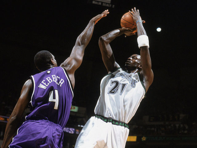 MINNEAPOLIS - MAY 19: Kevin Garnett #21 of the Minnesota Timberwolves puts a shot up against Chris Webber #4 of the Sacramento Kings in Game Seven of the Western Conference Semifinals during the 2004 NBA Playoffs at Target Center on May 19, 2004 in Minneapolis, Minnesota. The Timberwolves won 83-80. NOTE TO USER: User expressly acknowledges and agrees that, by downloading and/or using this Photograph, User is consenting to the terms and conditions of the Getty Images License Agreement.