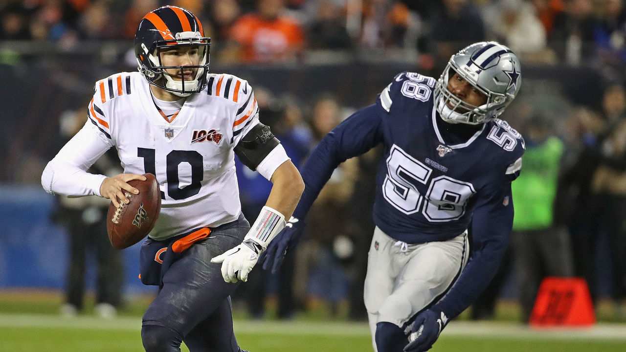 CHICAGO, ILLINOIS - DECEMBER 05: Mitchell Trubisky #10 of the Chicago Bears breaks away from Robert Quinn #58 of the Dallas Cowboys as he looks for a receiver at Soldier Field on December 05, 2019 in Chicago, Illinois. The Bears defeated the Cowboys 31-24.