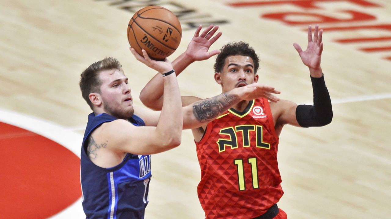 ATLANTA, GA - OCTOBER 24: Dallas Mavericks guard Luka Doncic (left) takes a shot against Atlanta Hawks guard Trae Young (11) during the first quarter of a NBA game on October 24, 2018 at State Farm Arena in Atlanta, GA.