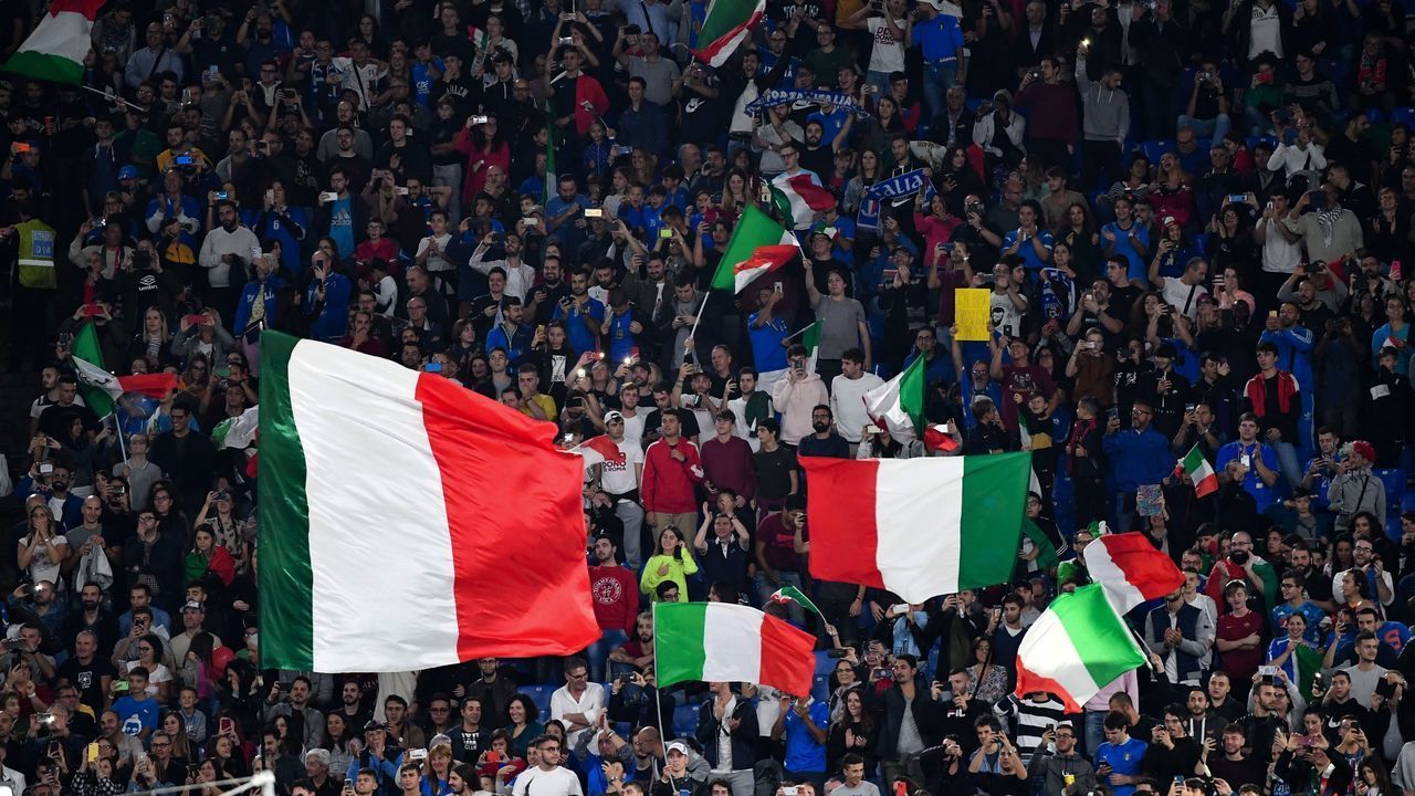 Italy's supporters wave Italian National flags during the UEFA Euro 2020 Group J qualifier football match between Italy and Greece at the Stadio Olimpico stadium in Rome, on October 12, 2019.