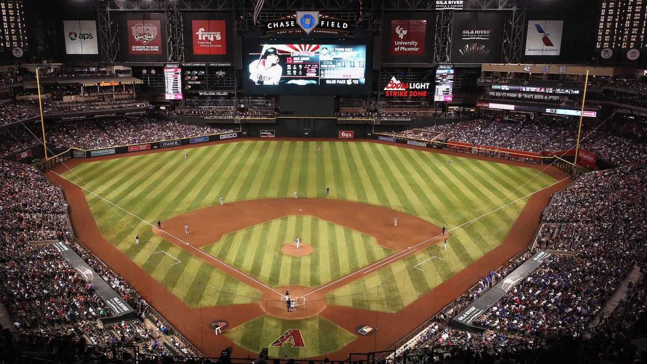 PHOENIX, ARIZONA - AUGUST 31: General view of action as relief pitcher Pedro Baez #52 of the Los Angeles Dodgers pitches against Nick Ahmed #13 of the Arizona Diamondbacks during the seventh inning of the MLB game at Chase Field on August 31, 2019 in Phoenix, Arizona. The Diamondbacks set an attendance record with a sold-out crowd of 50,180.