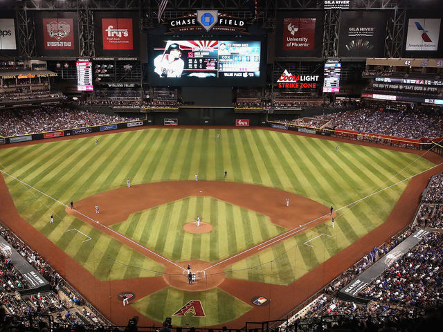 PHOENIX, ARIZONA - AUGUST 31: General view of action as relief pitcher Pedro Baez #52 of the Los Angeles Dodgers pitches against Nick Ahmed #13 of the Arizona Diamondbacks during the seventh inning of the MLB game at Chase Field on August 31, 2019 in Phoenix, Arizona. The Diamondbacks set an attendance record with a sold-out crowd of 50,180.