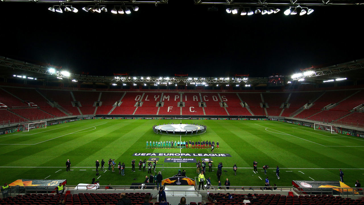 PIRAEUS, GREECE - MARCH 12: (FREE FOR EDITORIAL USE) In this handout image provided by UEFA, General view of empty seats as the teams line up prior to the UEFA Europa League round of 16 first leg match between Olympiacos FC and Wolverhampton Wanderers at Karaiskakis Stadium on March 12, 2020 in Piraeus, Greece. The match is played behind closed doors as a precaution against the spread of COVID-19 (Coronavirus).