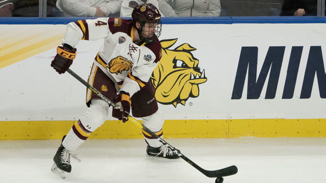 BUFFALO, NY - APRIL 13: Minnesota Duluth Bulldogs Defenseman Dylan Samberg (4) controls the puck during the first period of the NCAA Hockey Frozen Four championship game between the Massachusetts Minutemen and the Minnesota Duluth Bulldogs on April 13, 2019, at KeyBank Center in Buffalo, NY.