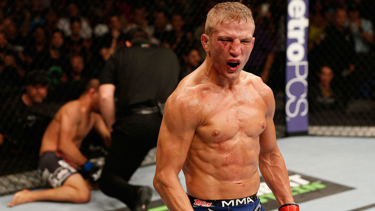 SACRAMENTO, CA - AUGUST 30: T.J. Dillashaw celebrates after his knockout victory over Joe Soto in their UFC bantamweight championship bout during the UFC 177 event at Sleep Train Arena on August 30, 2014 in Sacramento, California.