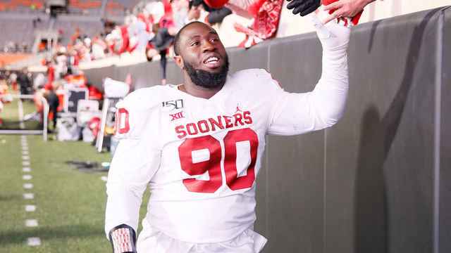STILLWATER, OK - NOVEMBER 30: Oklahoma Sooners DL Neville Gallimore (90) celebrates the Sooners win with the fans after a college football game between the Oklahoma State Cowboys and the Oklahoma Sooners on November 30, 2019, at Boone Pickens Stadium in Stillwater, OK.